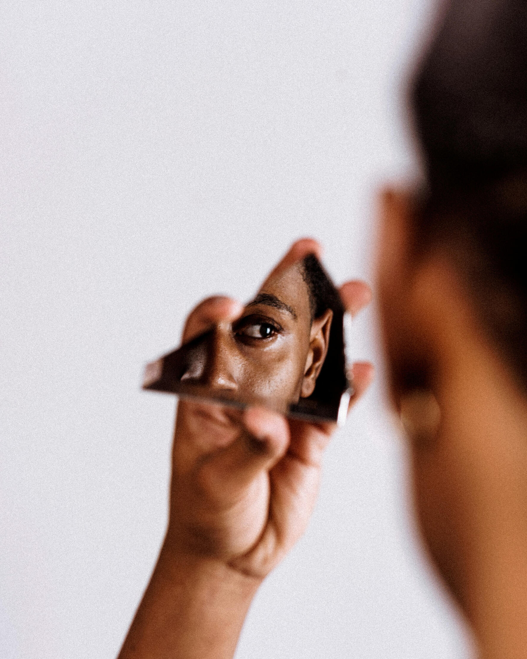 man holding broken mirror Portrait of Xavier Evans by jurien huggins publushed March 27 2019 free to use under Unsplash License